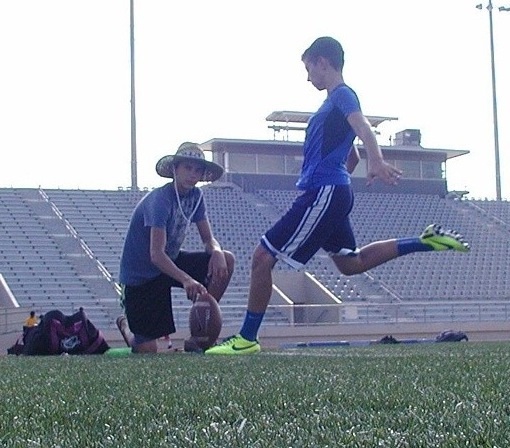 Freshman Trey Wolff prepares to perform a kick at football practice. 