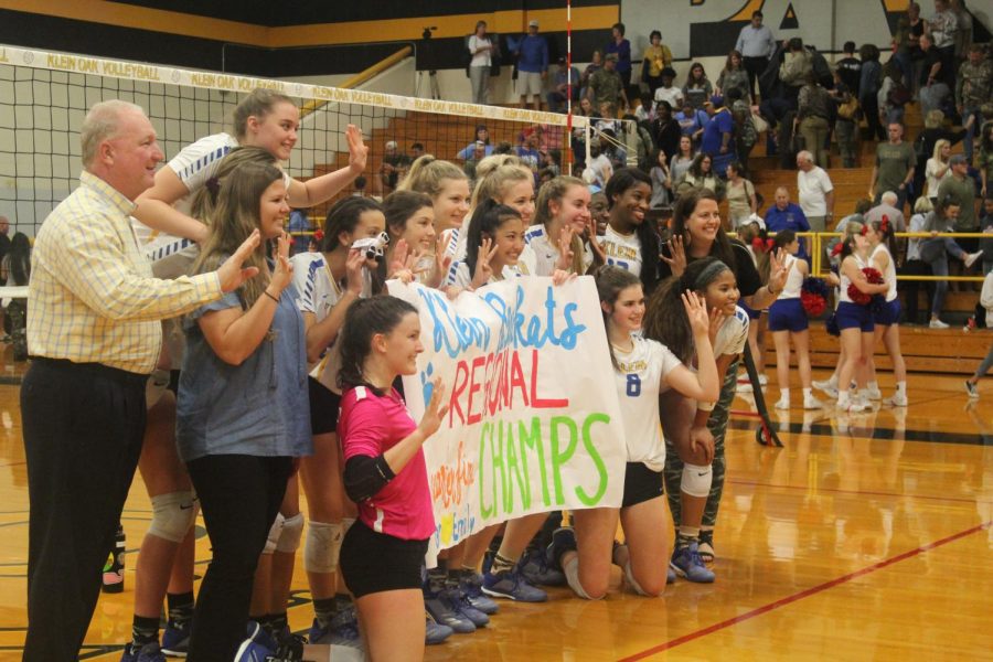 The lady Kats hold a sign to celebrate their round 3 playoff victory.