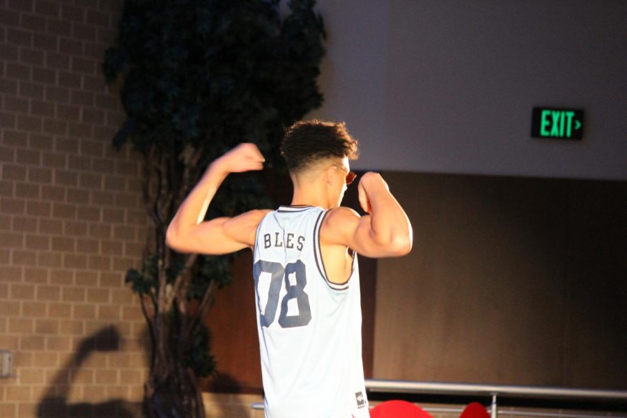 Senior Tyrone Killebrew wears a jersey as he shows off his biceps during his catwalk. 