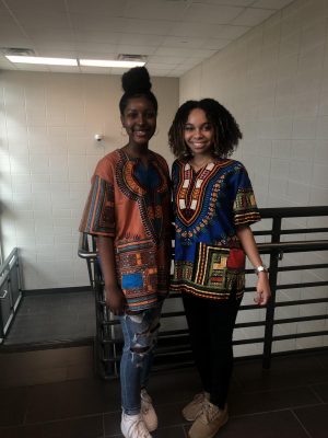 Seniors Myah McNair and Maya Monroe dressed in African patterened shirts.