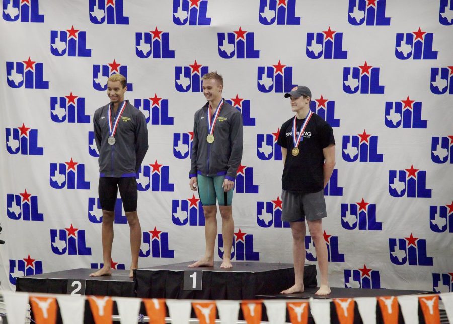 Top three stand on the podium for medals and pictures. Seniors Jacob Powell and Caleb Duncan in first and second, respectively.