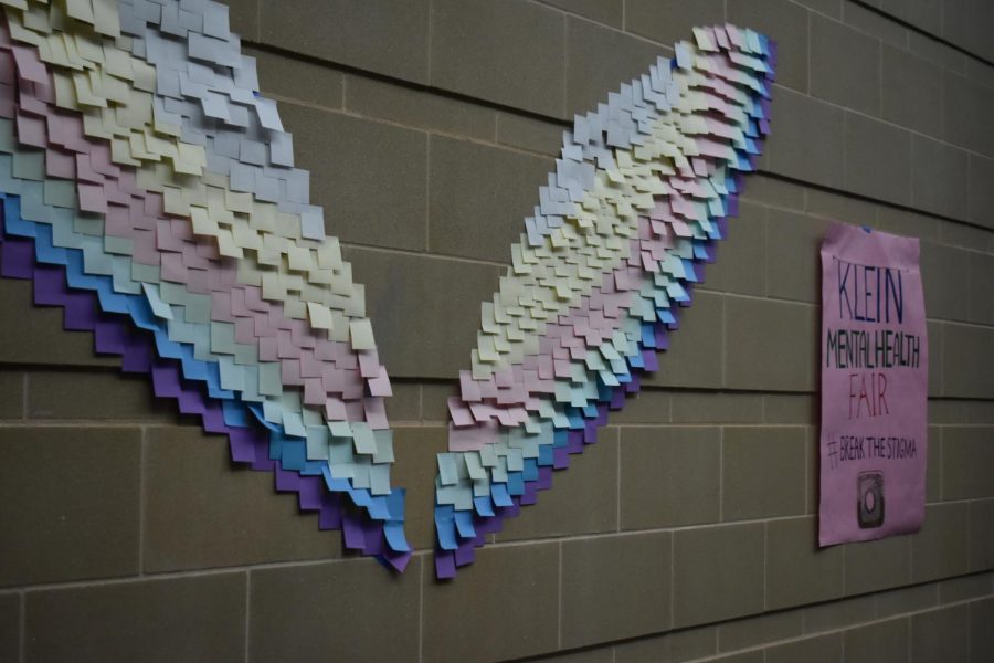 A pair of wings made of different colored sticky notes, made by Klein High Students during the Mental Health Awareness Fair