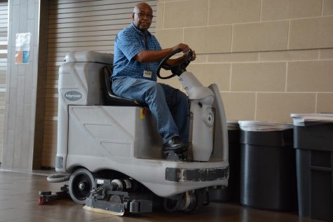 Head Custodian Larry Shaw cleans the cafeteria after the last lunch
