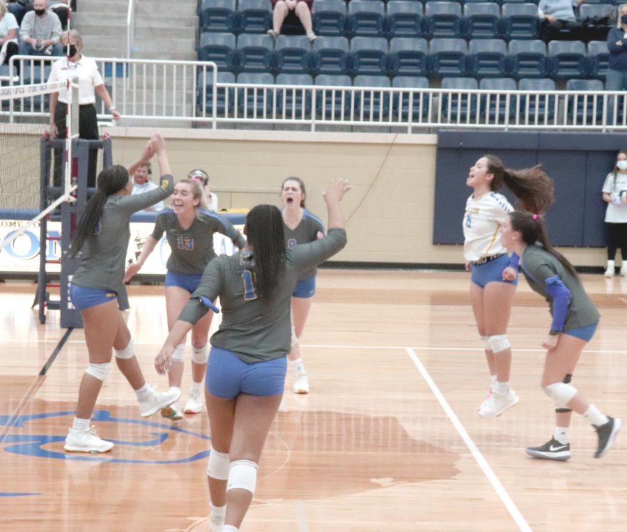The volleyball team celebrates after advancing to the state championship game Tuesday. They defeated Flower Mound in 3 straight sets .
