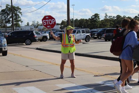After school, crossing guard Beth Lofland offers motivating words to passing students.