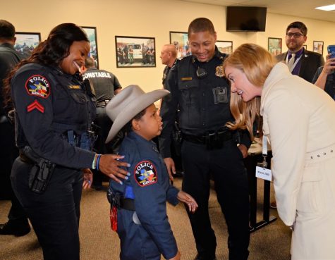 Klein ISD Superintendent Dr. Jenny McGown congratulates young DJ Daniel on his accomplishment to being sworn in as an honorary Klein ISD police officer.