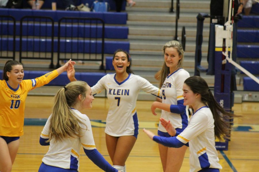 The varsity volleyball team celebrates another win for their 2021-2022 season.