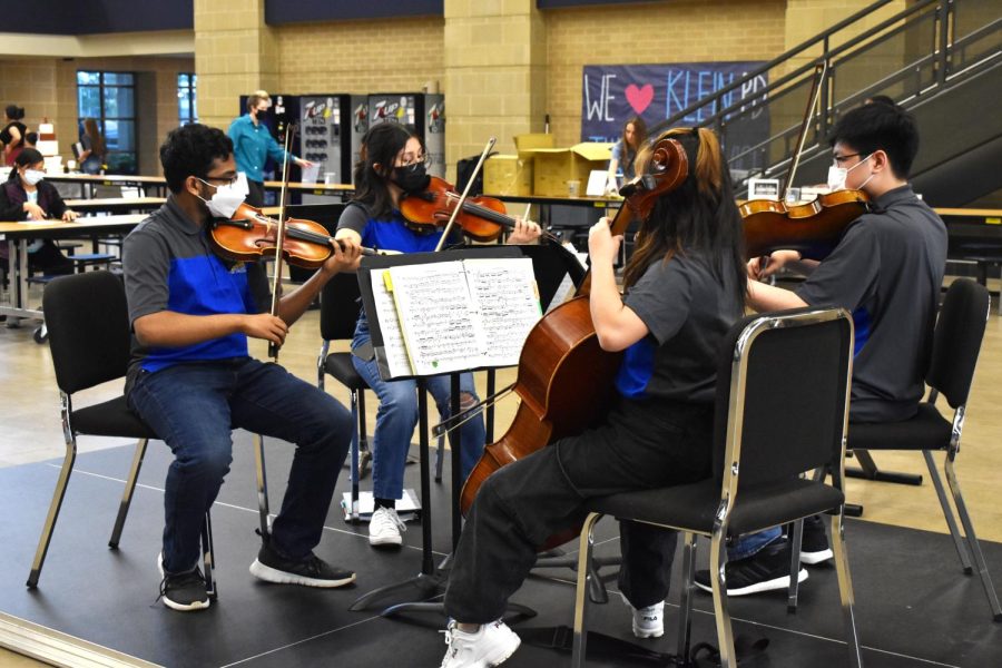 Orchestra students leave passing students, parents, and faculty in awe as they play classical music to  keep the Taste of Klein attendants entertained.