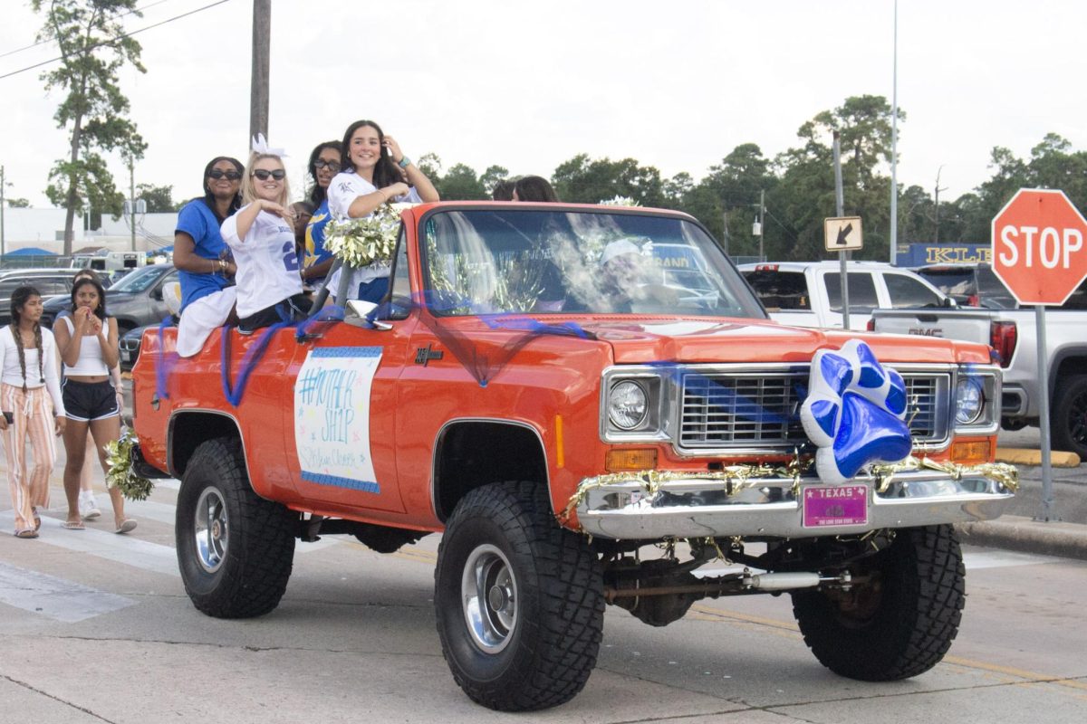 A group of senior cheerleaders float down the senior parade.