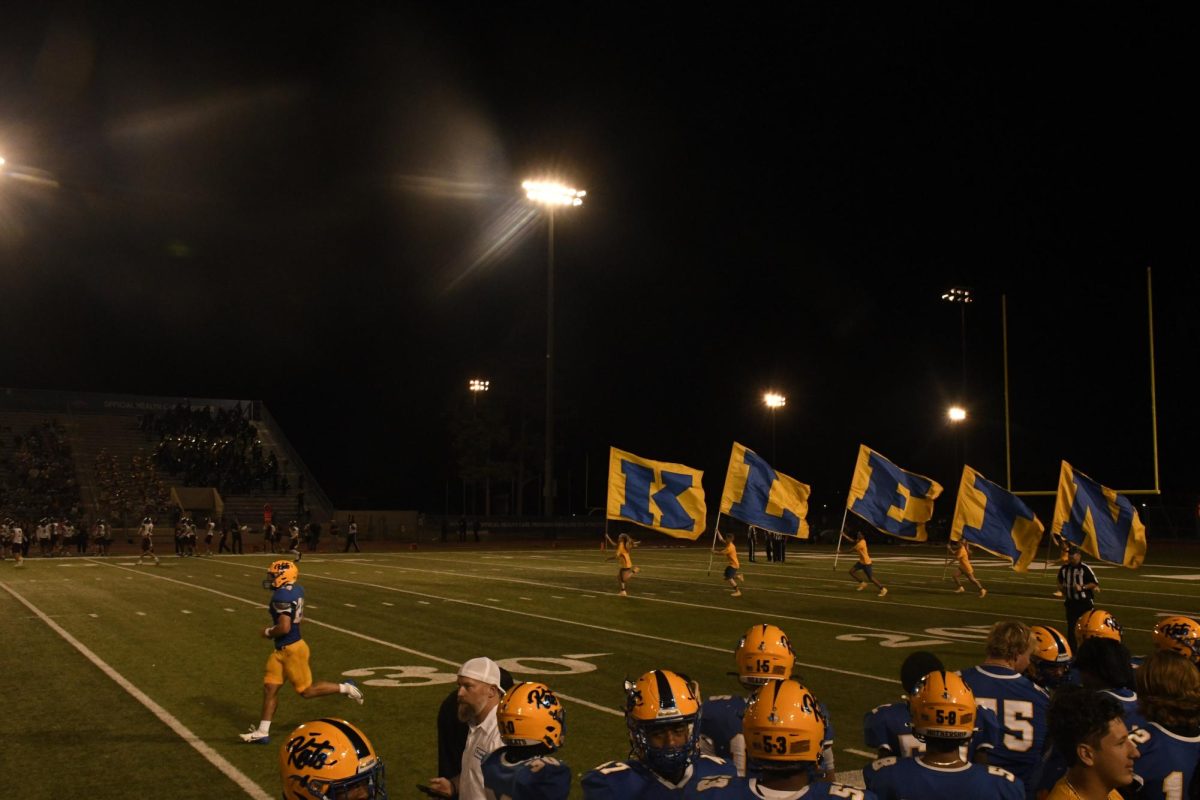 Standleaders run flags after touchdown at homecoming game.