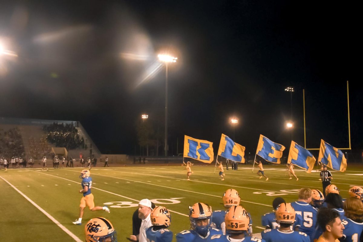 Standleaders run flags after touchdown at homecoming game.